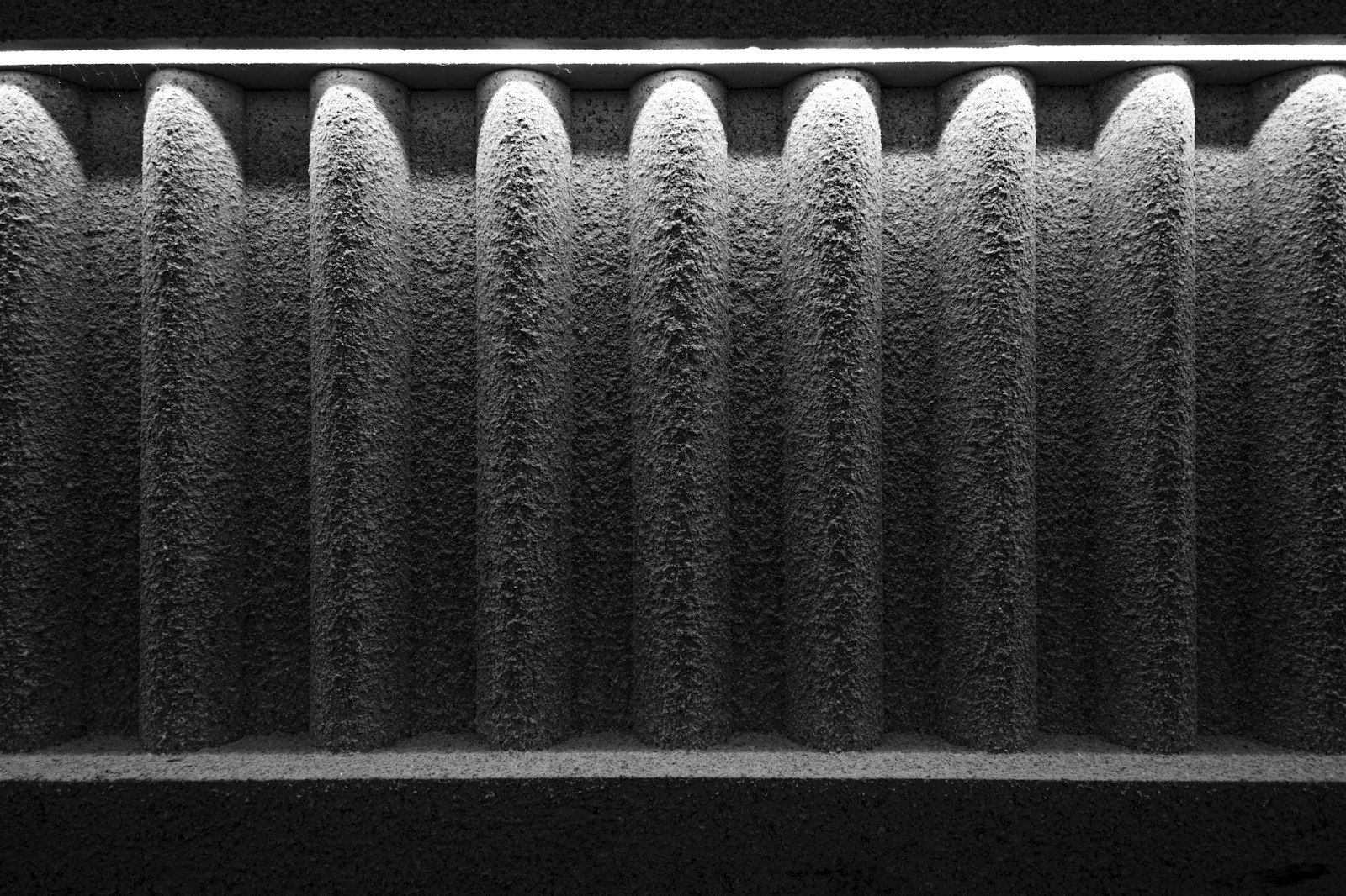 A close-up of a dusty, clogged pleated air filter.
