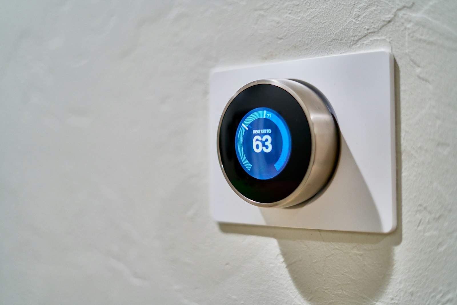 A wall-mounted smart thermostat showing the current setting.